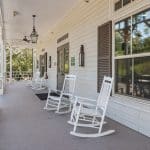 Front porch with white rocking chairs at Longbranch Recovery in Covington LA