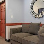 Retreat of Atlanta view of the hallway with a brown sofa and a view into a bedroom