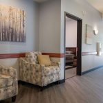 Retreat of Atlanta view of the hallway with two patterned chairs and a view into a bedroom