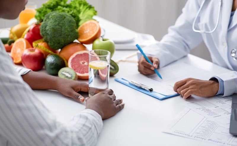Nutritionist and patient receiving nutritional holistic eating disorder care.