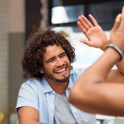 Man and woman high fiving in a sober living environment in Alabama.